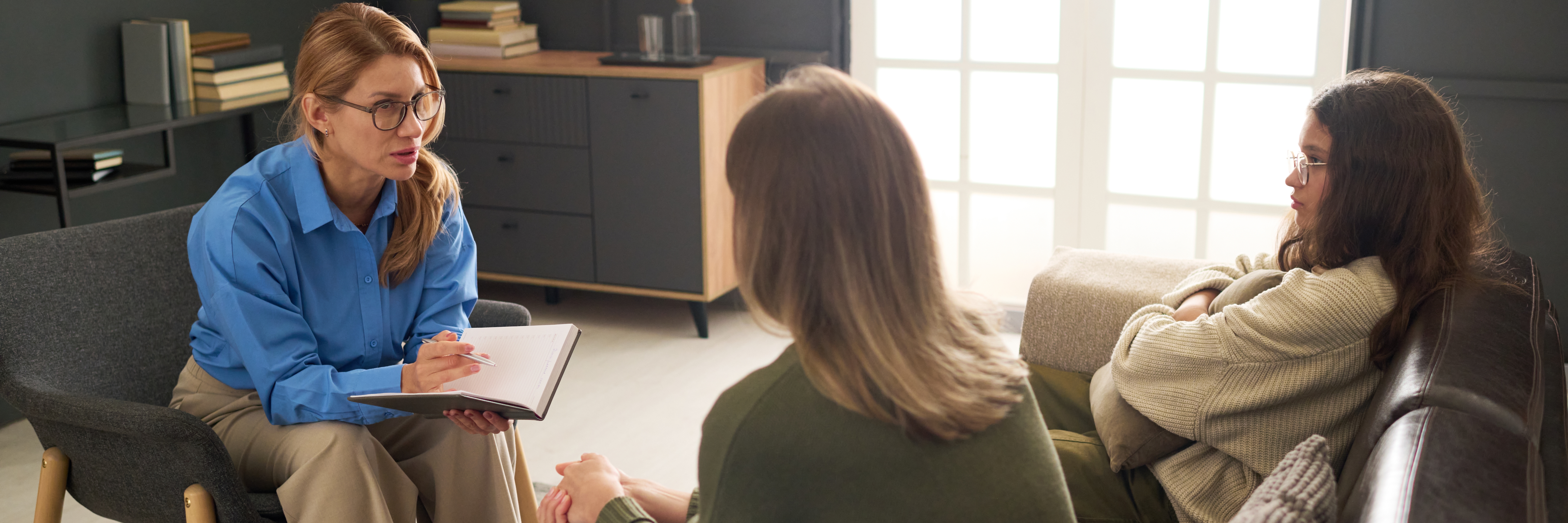 Header image of female therapist consulting mother and daughter fighting during family counseling session