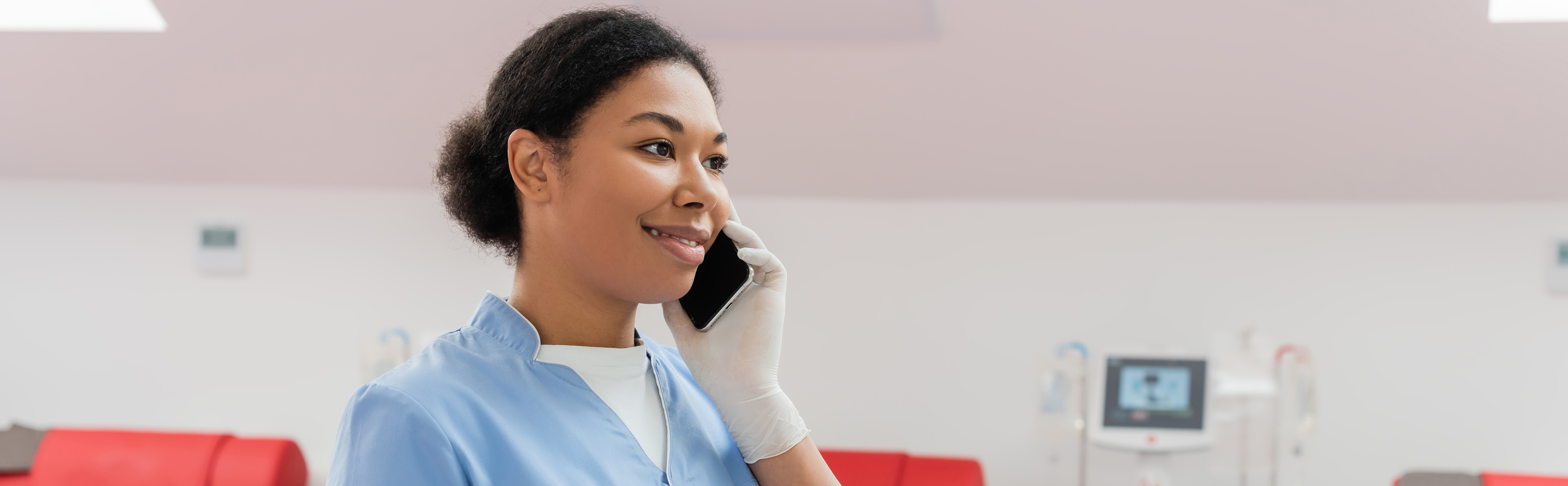 Women talking on the phone. She has rubber gloves on.