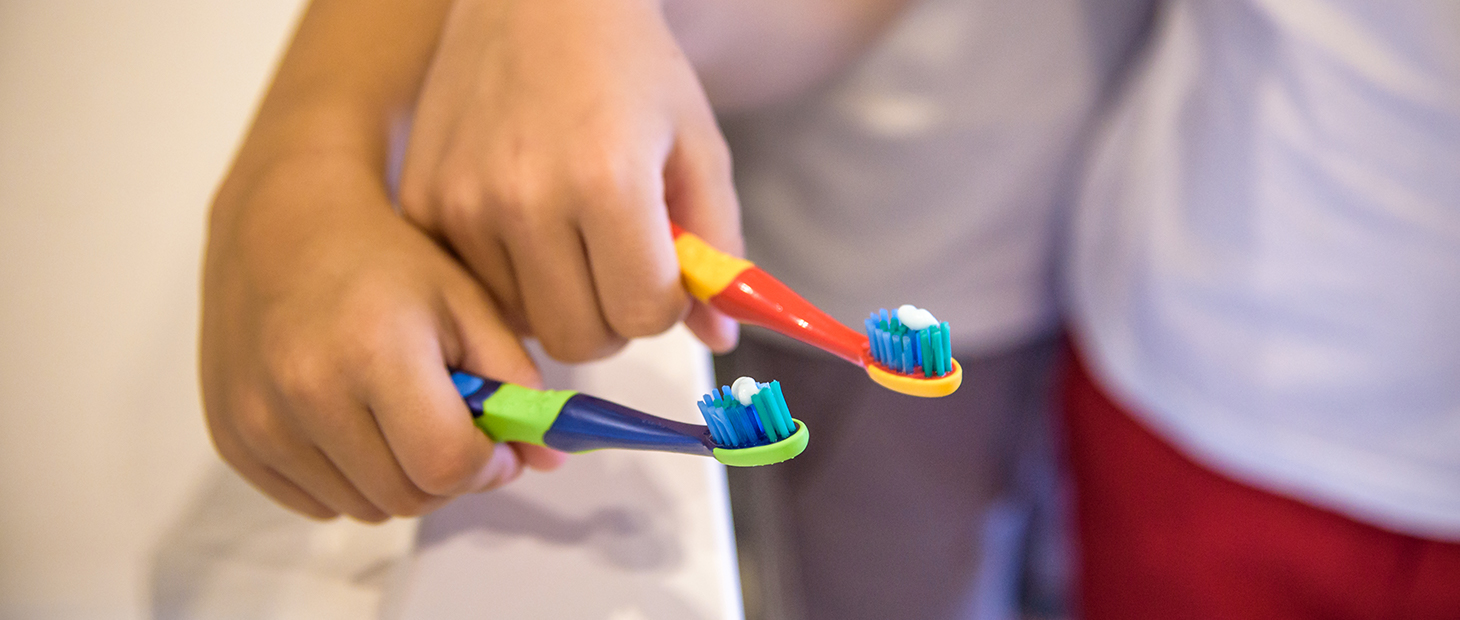 Kids holding toothbrushes